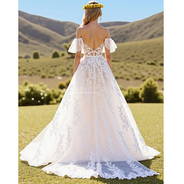 Vestido de novia de línea A con hombros descubiertos y volantes en color marfil