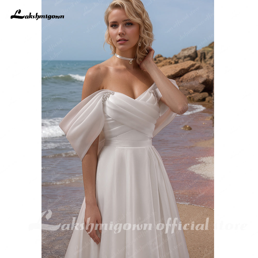 Vestidos de novia de organza con hombros descubiertos Vestidos de novia de una línea sin tirantes con pliegues clásicos